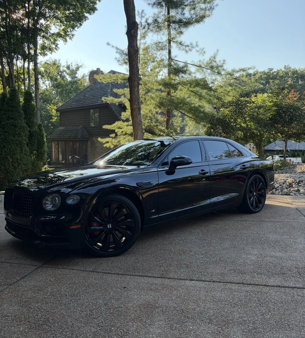 Front three quarter view of a black 2022 Bentley Flying Spur after a one step paint correction and 5 year ceramic coating by David's Auto Spa in Edwardsville, Illinois