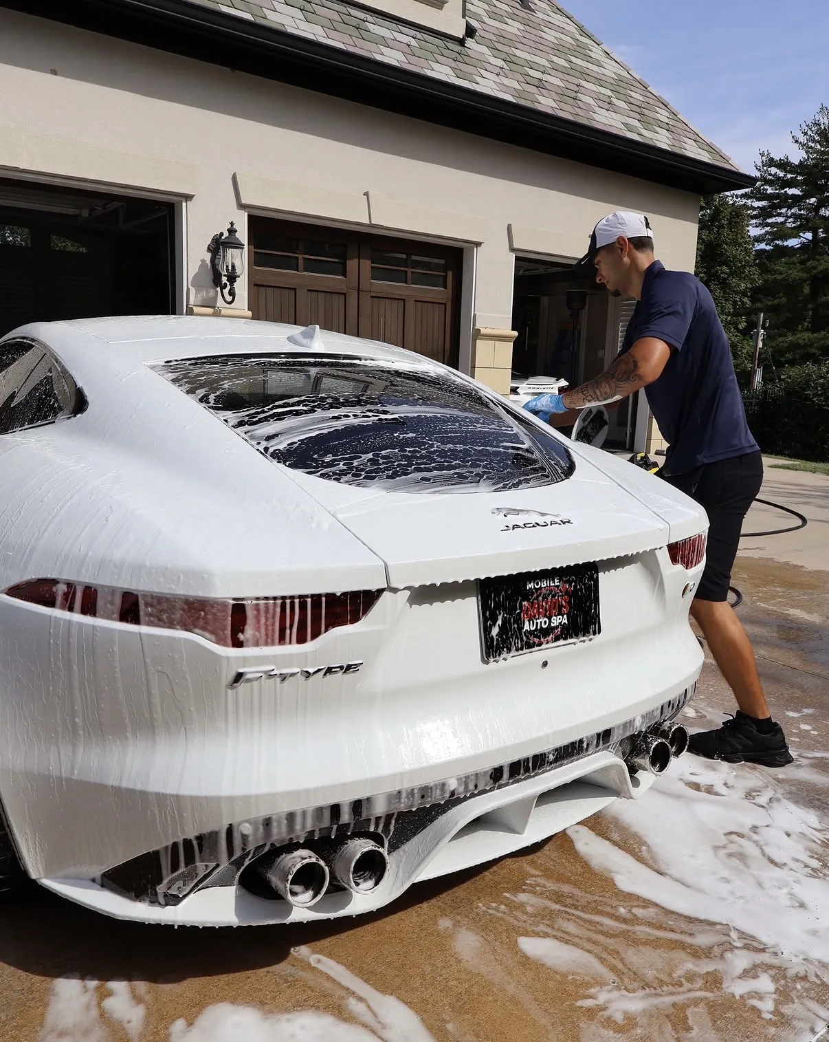 White Jaguar F-Type receiving an exterior wash